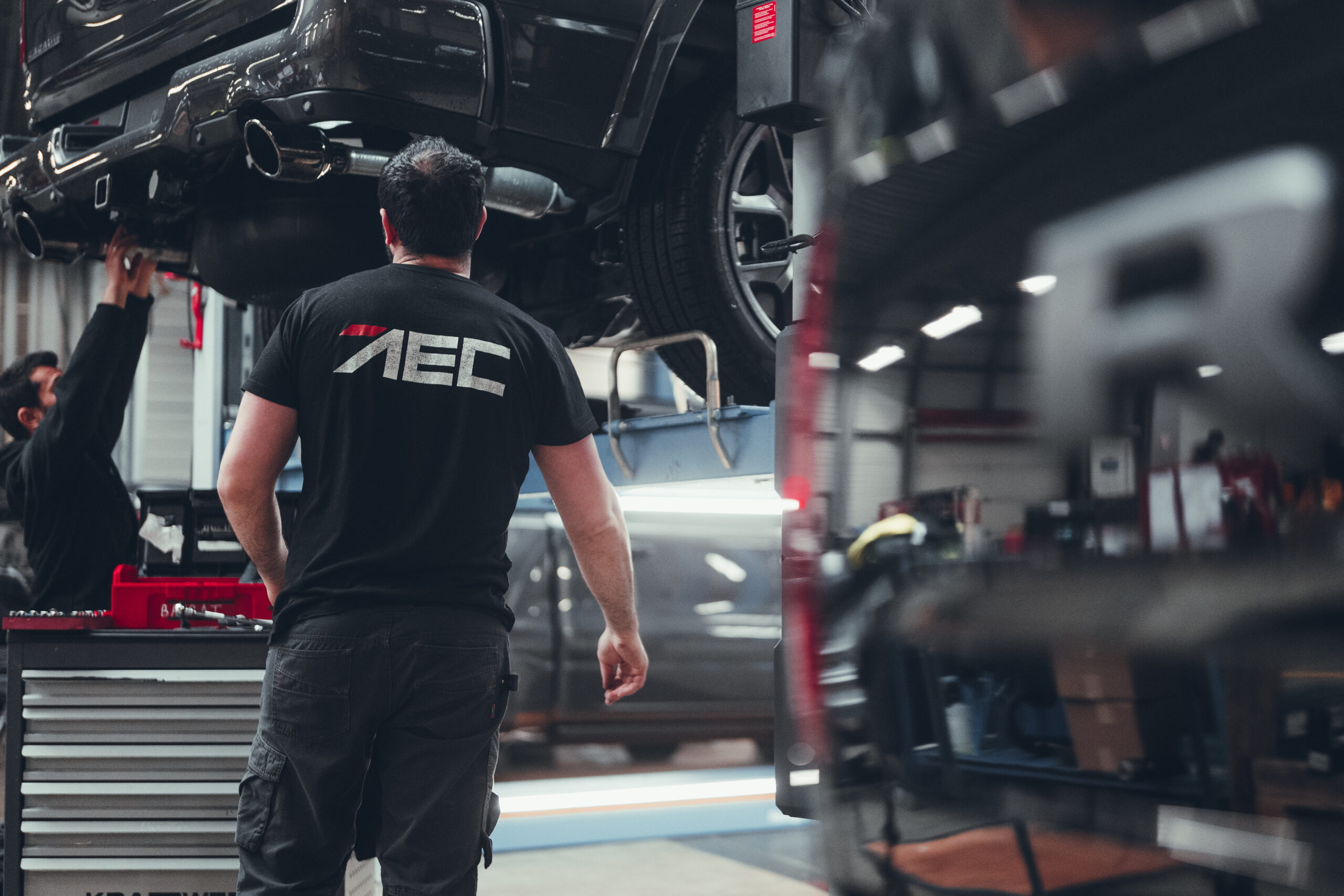 AEC technician carrying out vehicle processing and technical preparation before dealer delivery
